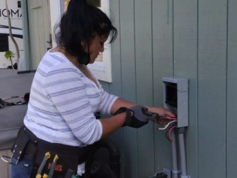 Licensed electrician wiring an exterior subpanel in Sterling